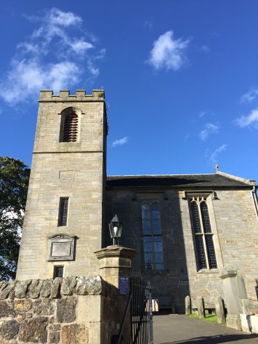 Church with tower against blue sky